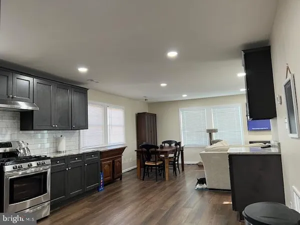a kitchen with stainless steel appliances kitchen island granite countertop a sink and cabinets
