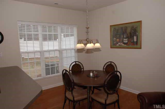 7038 Racine Way Raleigh, NC 27615 - Photo 6 of 12 Dining room with hardwoods and large picture window Other