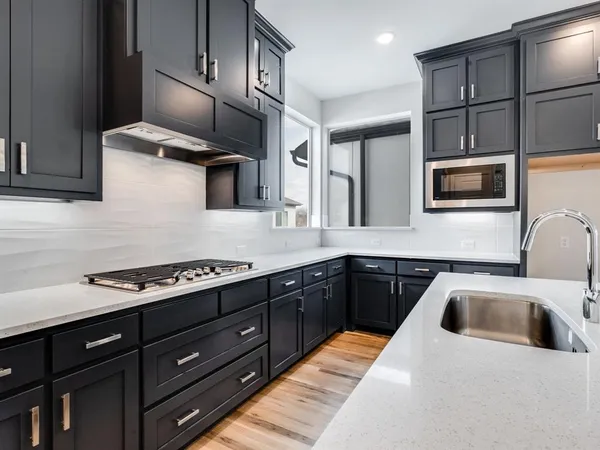 a kitchen with stainless steel appliances wooden cabinets and a sink