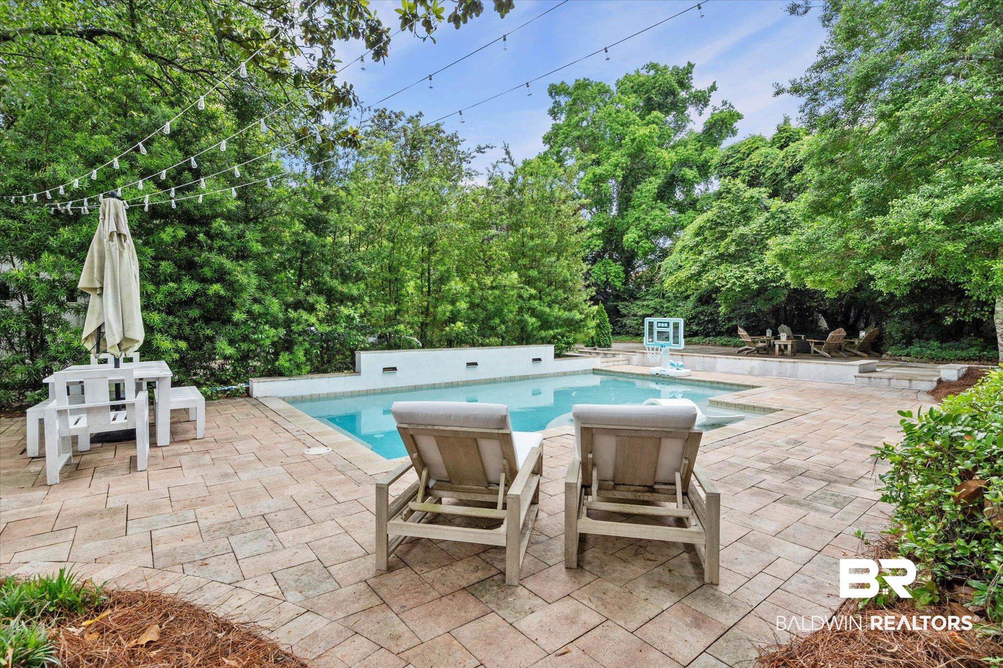 3863 Old Shell Road Mobile, AL 36608 - Photo 33 of 48 In-ground swimming pool with a surrounding paver patio and ample green space