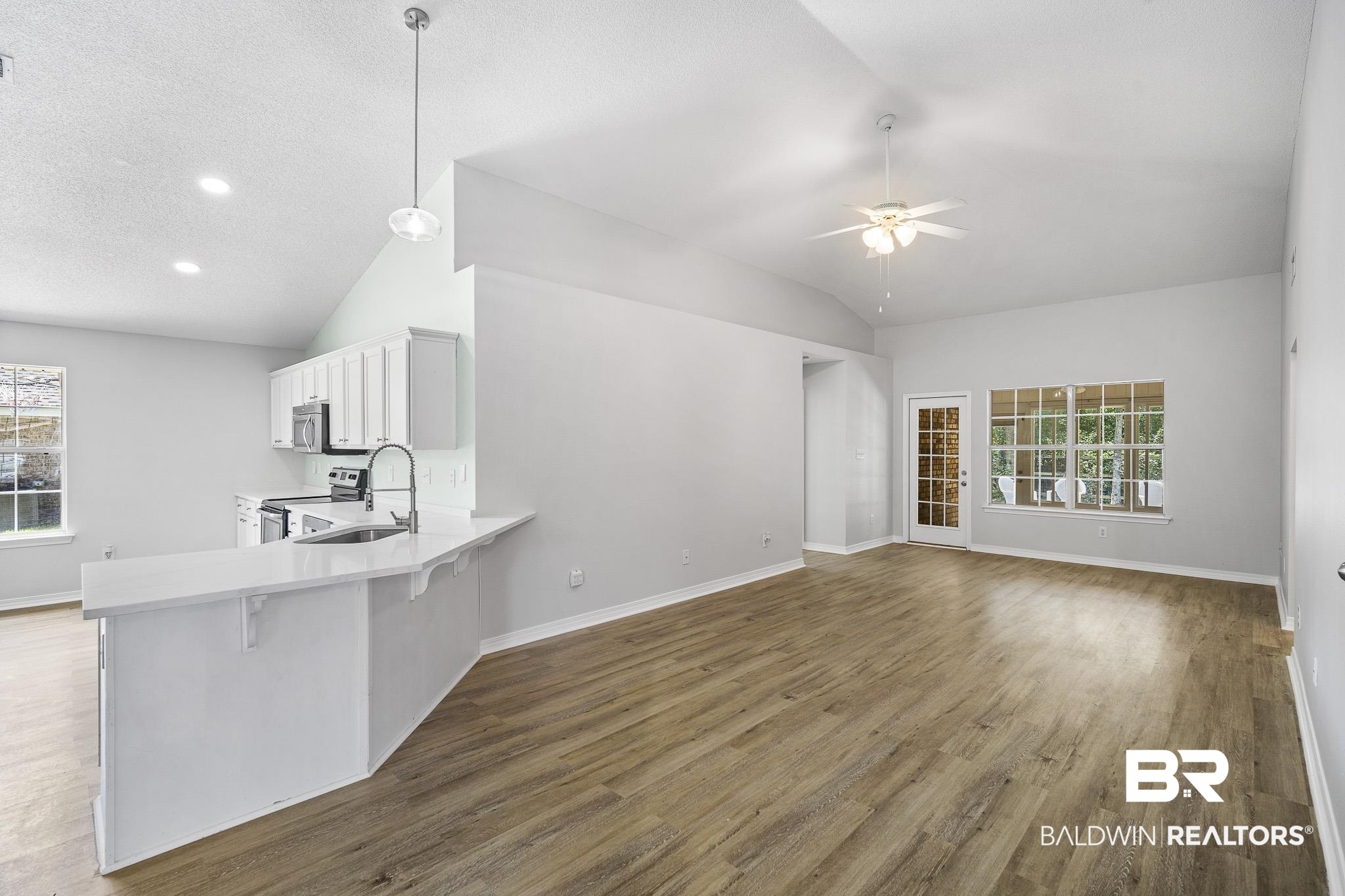 9814 Woolrich Avenue Fairhope, AL 36532 - Photo 8 of 29 Kitchen with ceiling fan, pendant lighting, hardwood / wood-style flooring, and stainless steel appliances