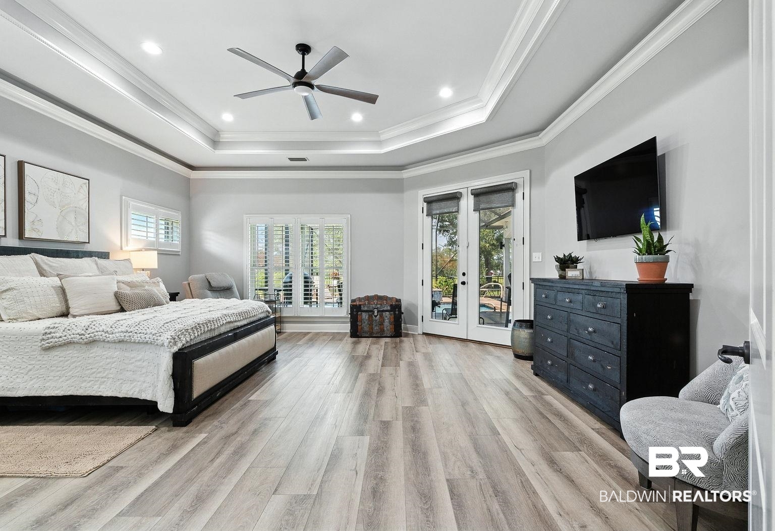 23357 Carnoustie Drive Foley, AL 36535 - Photo 46 of 99 Bedroom featuring access to exterior, light wood-type flooring, a raised ceiling, recessed lighting, and french doors