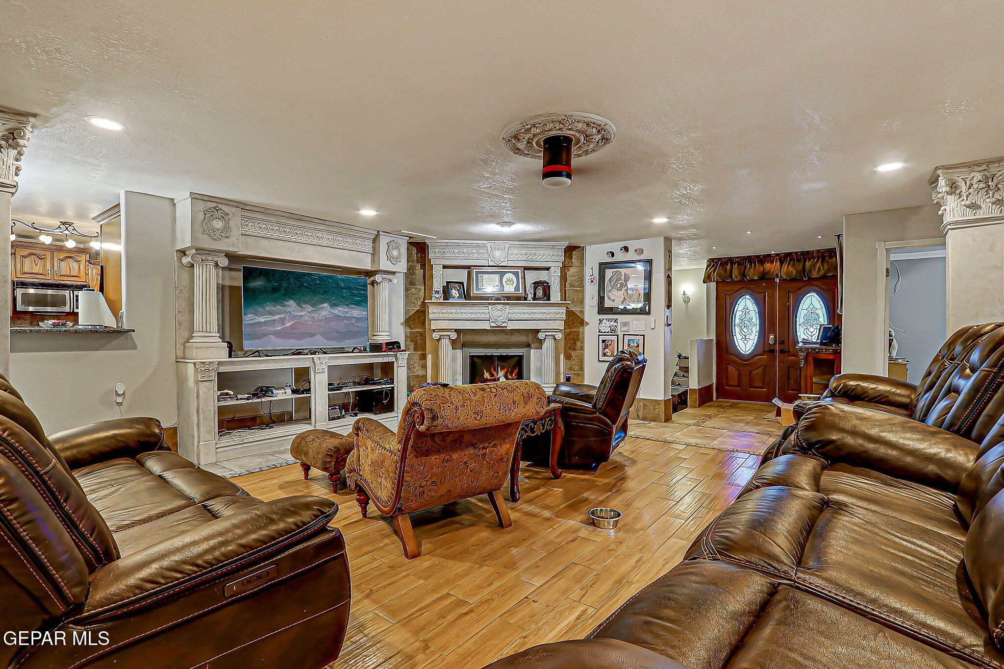 14800 Kingston Road Horizon City, TX 79928 - Photo 14 of 82 a living room with furniture a flat screen tv and a fireplace