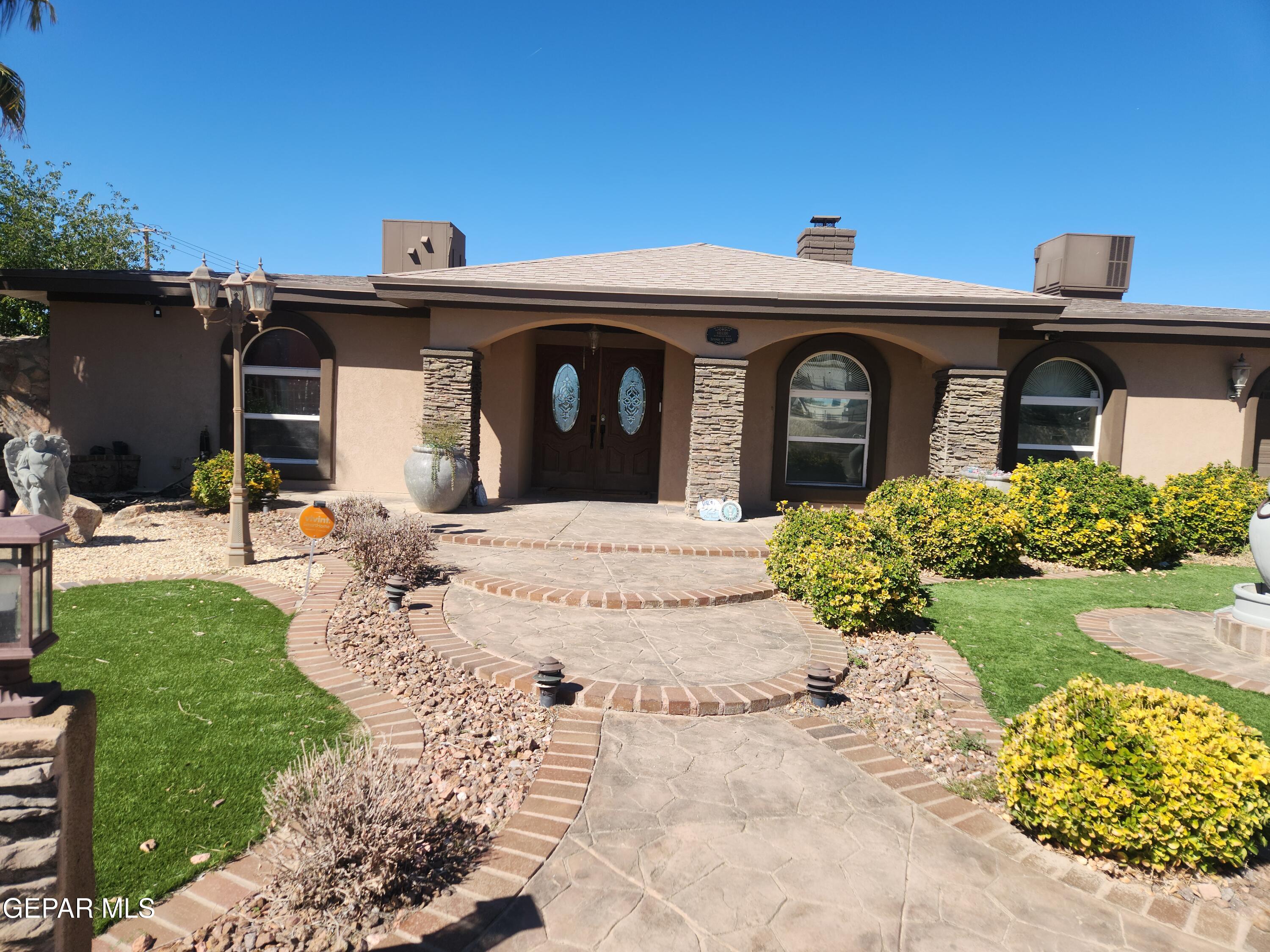 14800 Kingston Road Horizon City, TX 79928 - Photo 2 of 82 a front view of a house with a yard