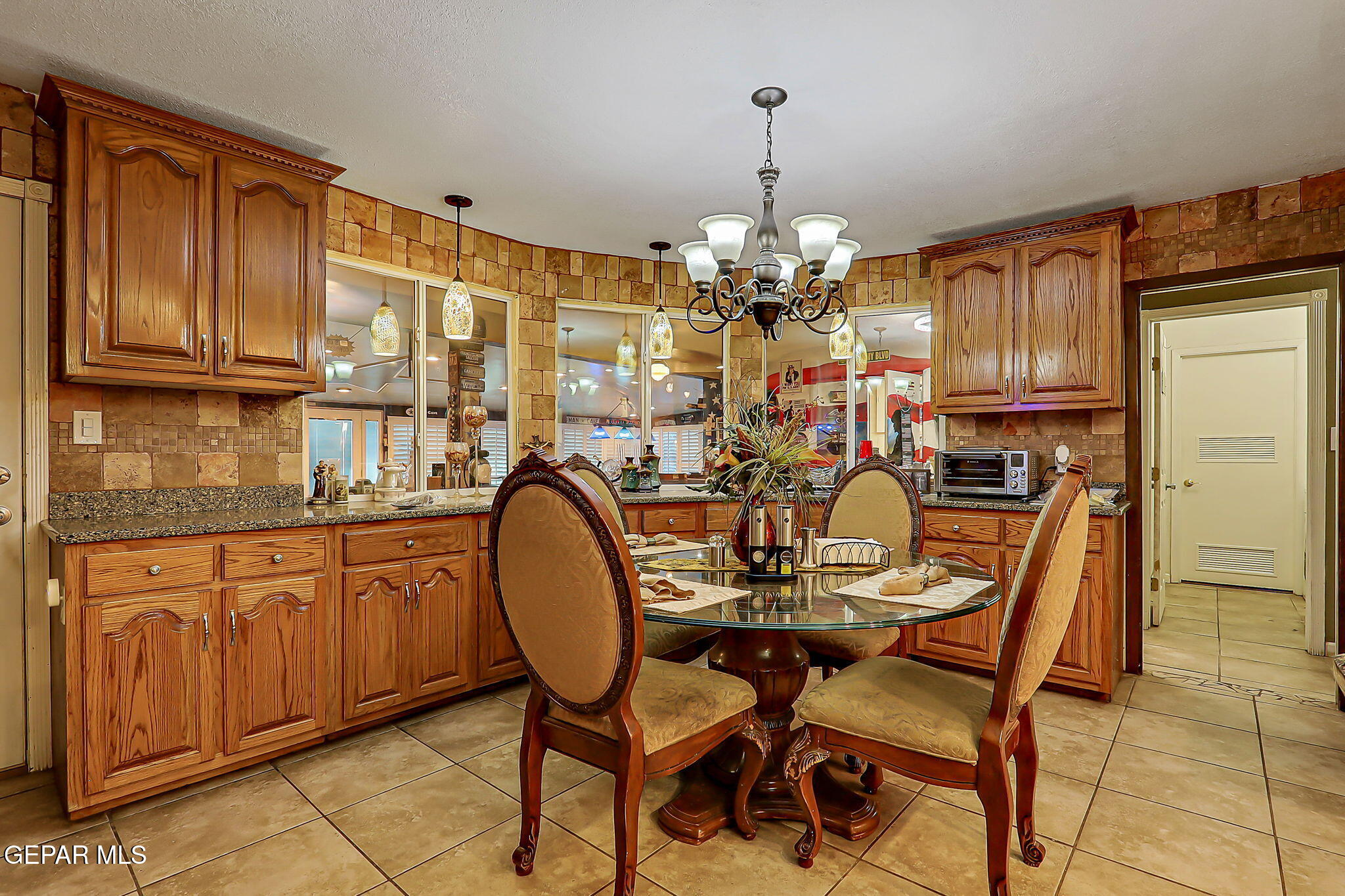 14800 Kingston Road Horizon City, TX 79928 - Photo 21 of 82 a view of a dining room with furniture kitchen and chandelier