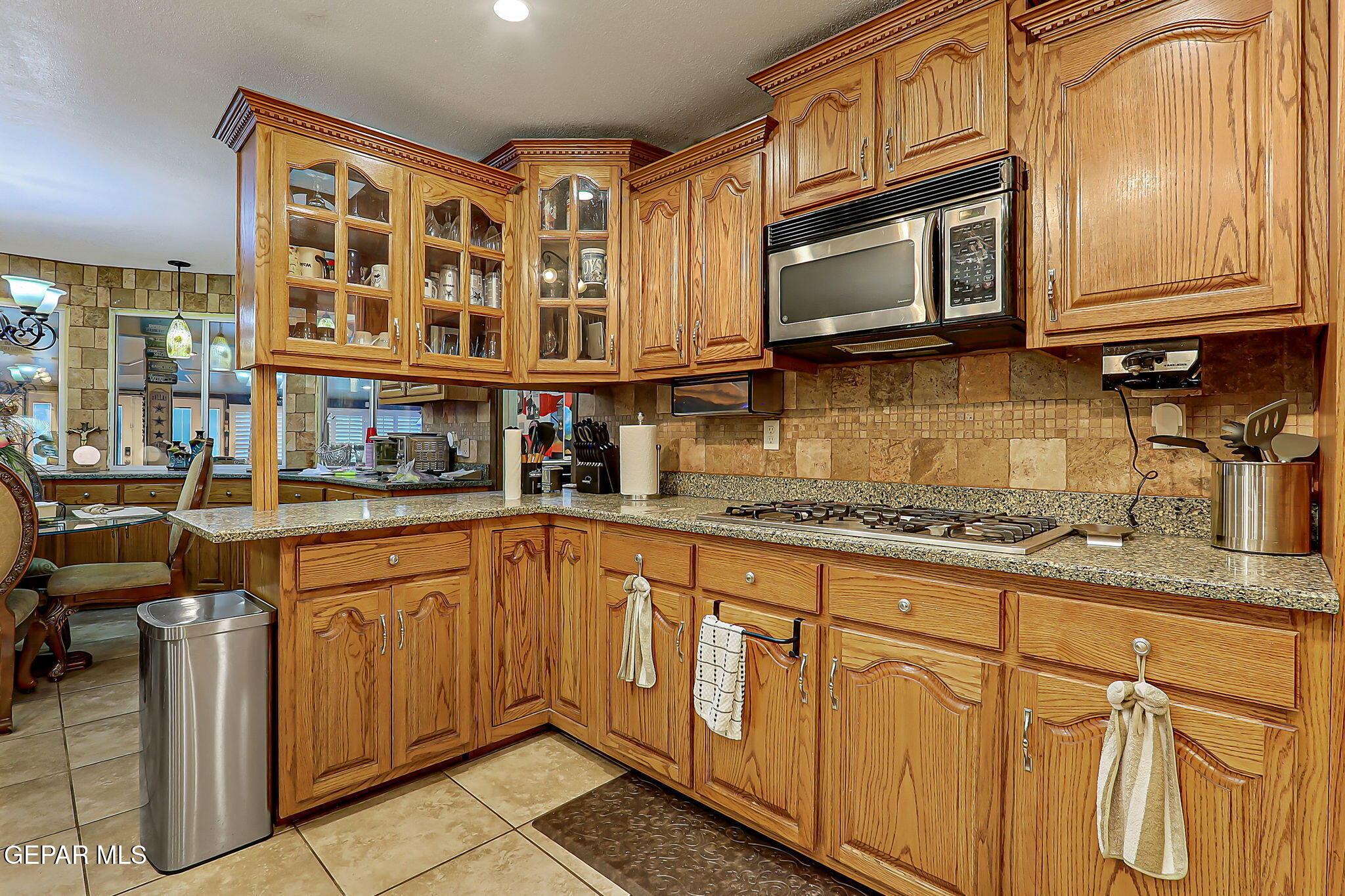 14800 Kingston Road Horizon City, TX 79928 - Photo 30 of 82 a kitchen with stainless steel appliances granite countertop a stove a sink and a microwave