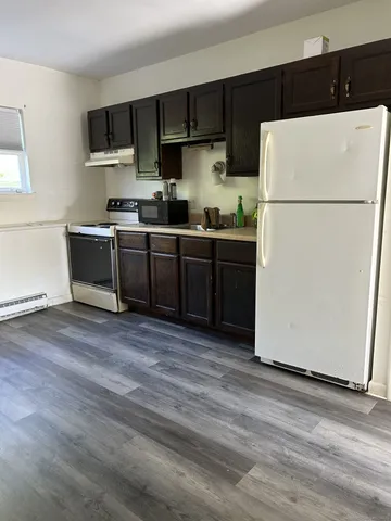 a kitchen with a refrigerator and a stove