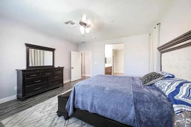 a bedroom with a bed and a dresser