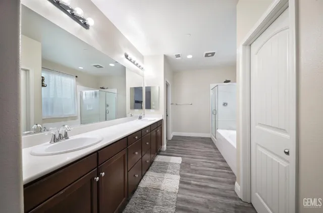 a bathroom with a double vanity sink and mirror