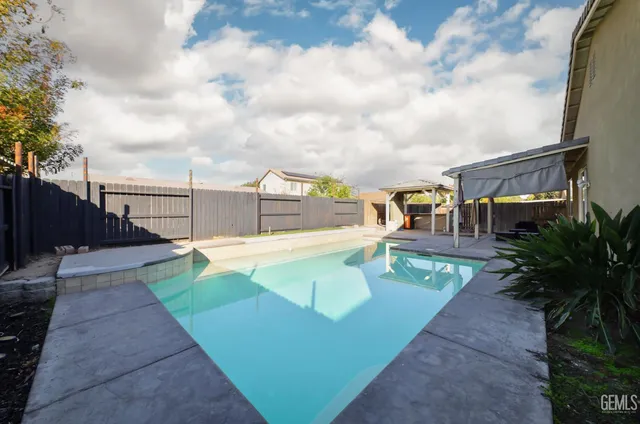 a view of a swimming pool with a patio