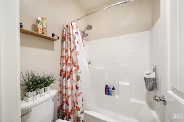 a bathroom with a shower curtain and a bathtub