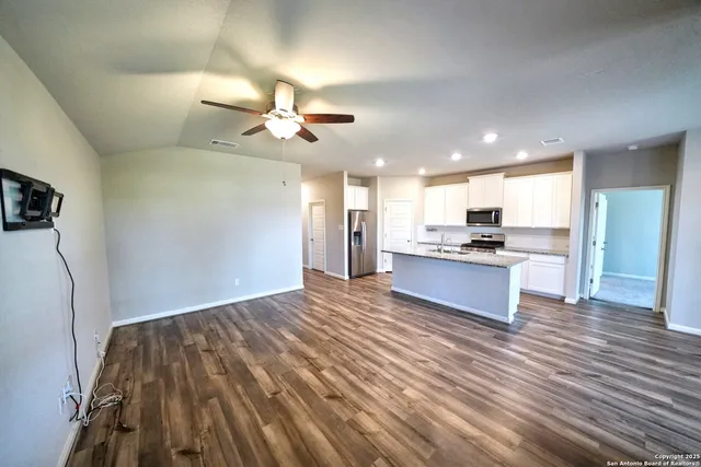 a view of kitchen with refrigerator microwave and stove
