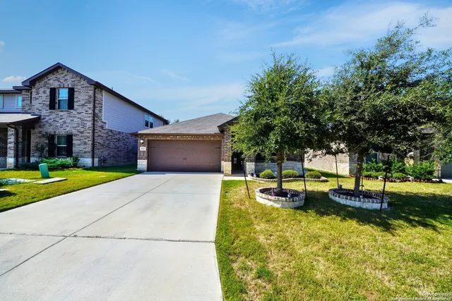 a view of a house with swimming pool and a yard