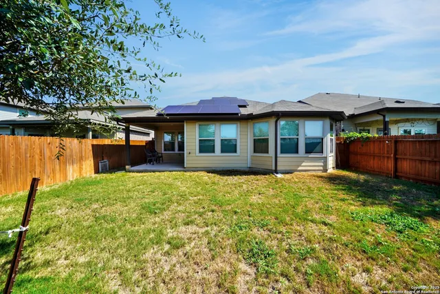 a view of a house with backyard and porch