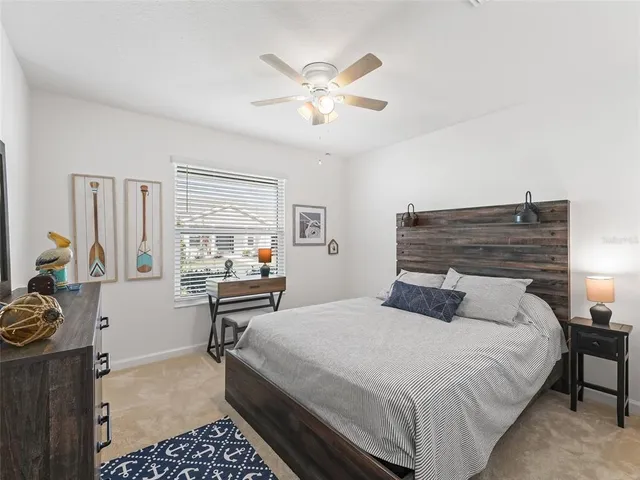 a bedroom with a bed and a table with chair