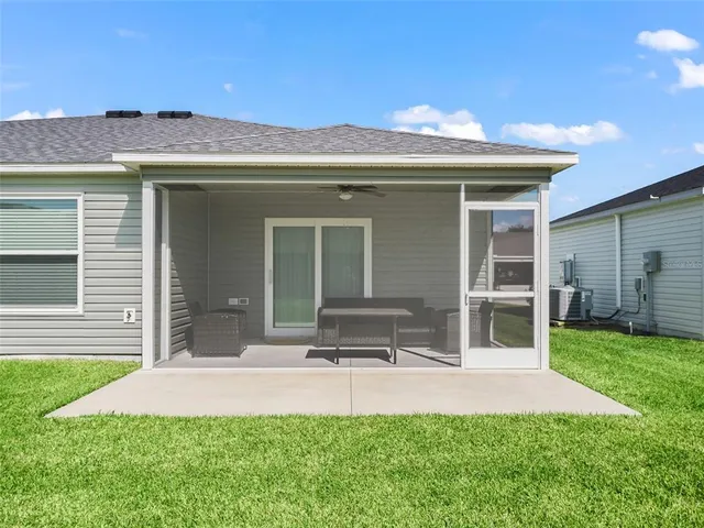 a view of a house with backyard porch and sitting area