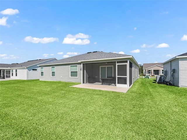 a front view of a house with a garden and yard