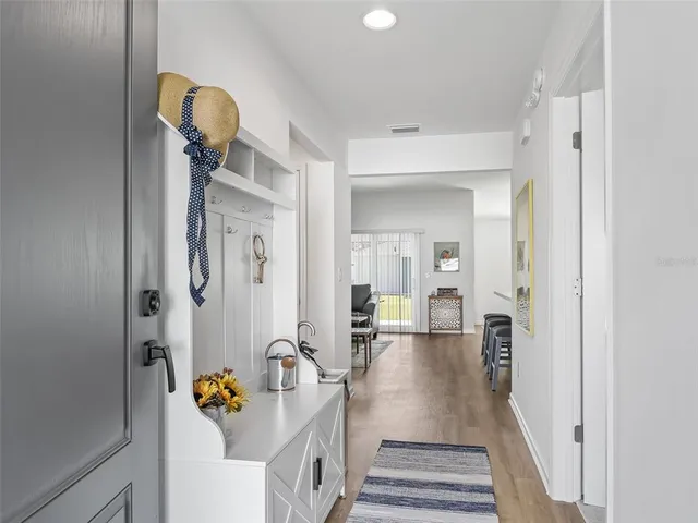 a view of an entryway with wooden floor