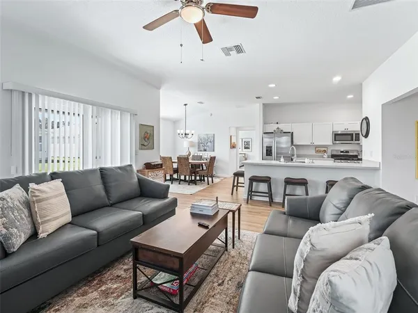 a living room with furniture and kitchen view