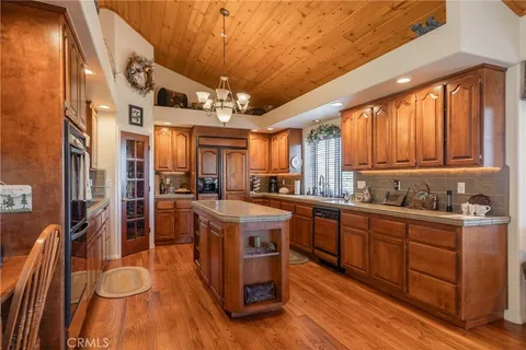 a kitchen with stainless steel appliances granite countertop wooden floors and sink