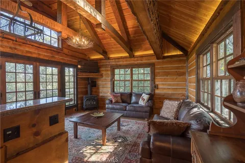 a living room with furniture a fireplace and a table