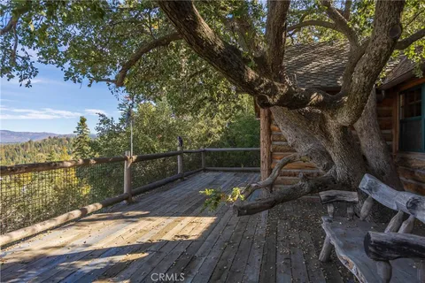a view of a balcony with wooden floor and fence