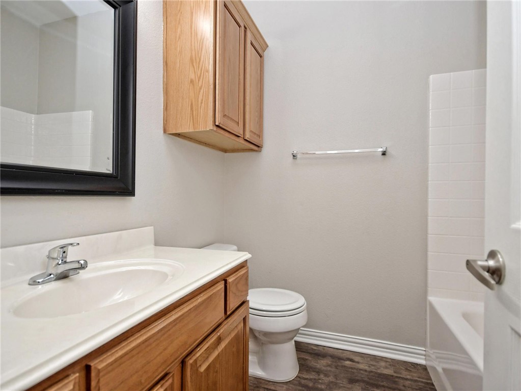 1001 Krenek Tap Road, Unit 2002 College Station, TX 77840 - Photo 12 of 20 a bathroom with a sink a toilet and mirror