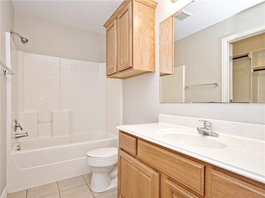 1001 Krenek Tap Road, Unit 2002 College Station, TX 77840 - Photo 18 of 20 a bathroom with a sink a toilet and a bathtub