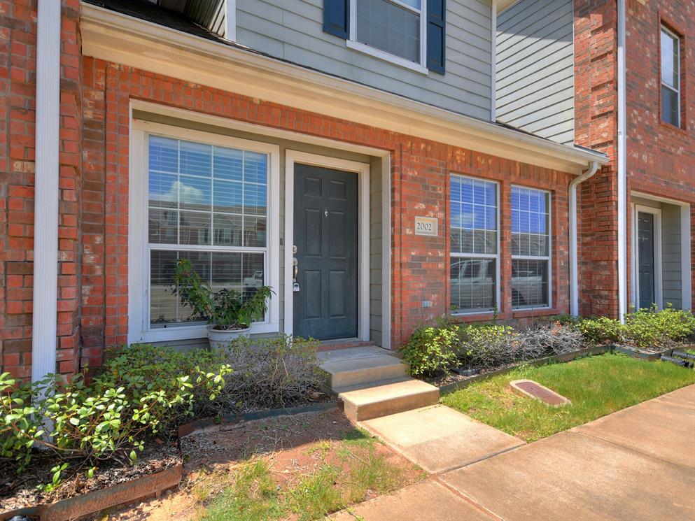 1001 Krenek Tap Road, Unit 2002 College Station, TX 77840 - Photo 3 of 20 a view of a house with brick walls plants and flower plants