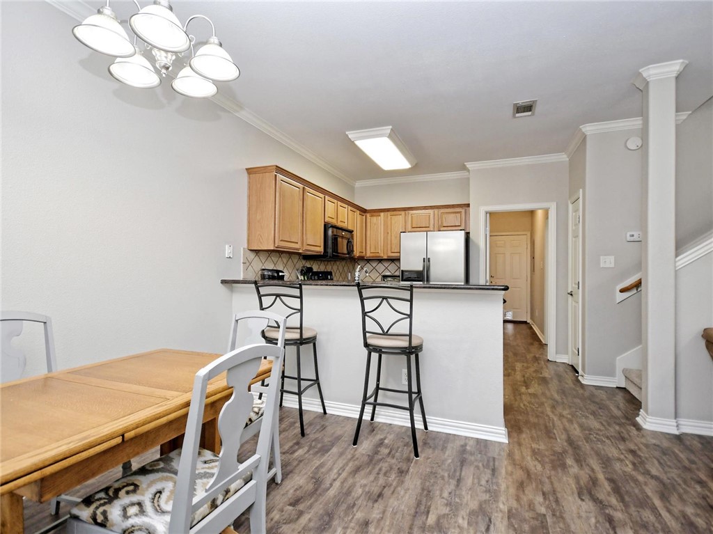 1001 Krenek Tap Road, Unit 2002 College Station, TX 77840 - Photo 7 of 20 a room with stainless steel appliances a kitchen island hardwood floor and a sink