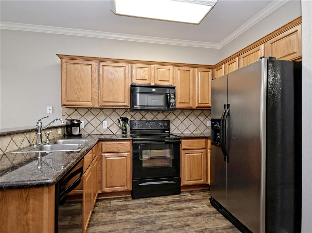 1001 Krenek Tap Road, Unit 2002 College Station, TX 77840 - Photo 8 of 20 a kitchen with granite countertop a refrigerator stove and sink