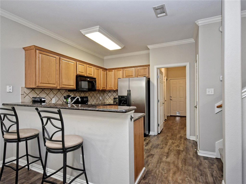 1001 Krenek Tap Road, Unit 2002 College Station, TX 77840 - Photo 9 of 20 a kitchen with stainless steel appliances granite countertop a refrigerator and a stove top oven