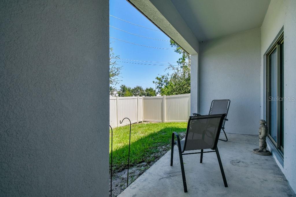 8331 Corner Pine Way New Port Richey, FL 34655 - Photo 11 of 41 a view of a chair and table in backyard of the house