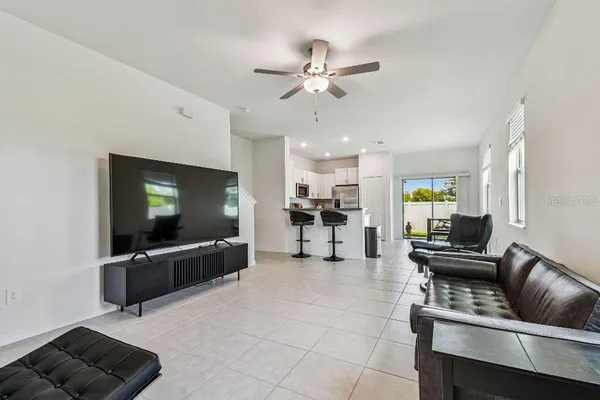 a living room with furniture and a ceiling fan