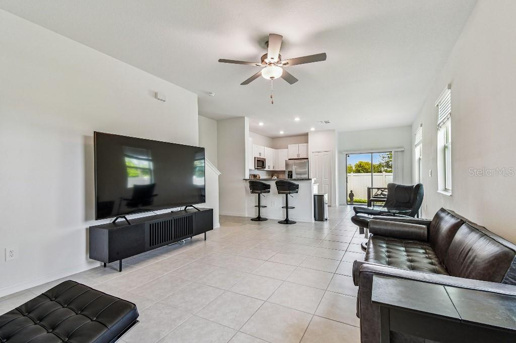 8331 Corner Pine Way New Port Richey, FL 34655 - Photo 13 of 41 a living room with furniture and a flat screen tv