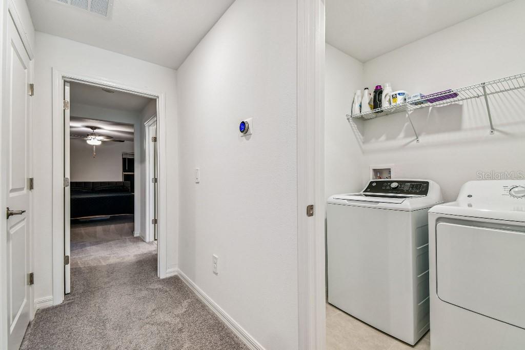 8331 Corner Pine Way New Port Richey, FL 34655 - Photo 15 of 41 a view of storage and utility room with washer and dryer