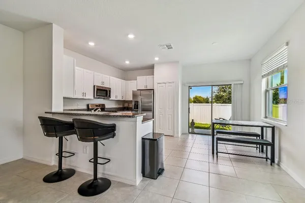 a kitchen with sink refrigerator and microwave