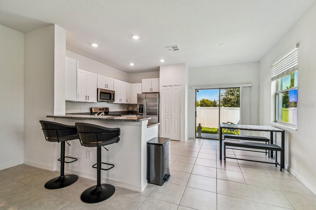 8331 Corner Pine Way New Port Richey, FL 34655 - Photo 16 of 41 a kitchen with a refrigerator a stove and a sink