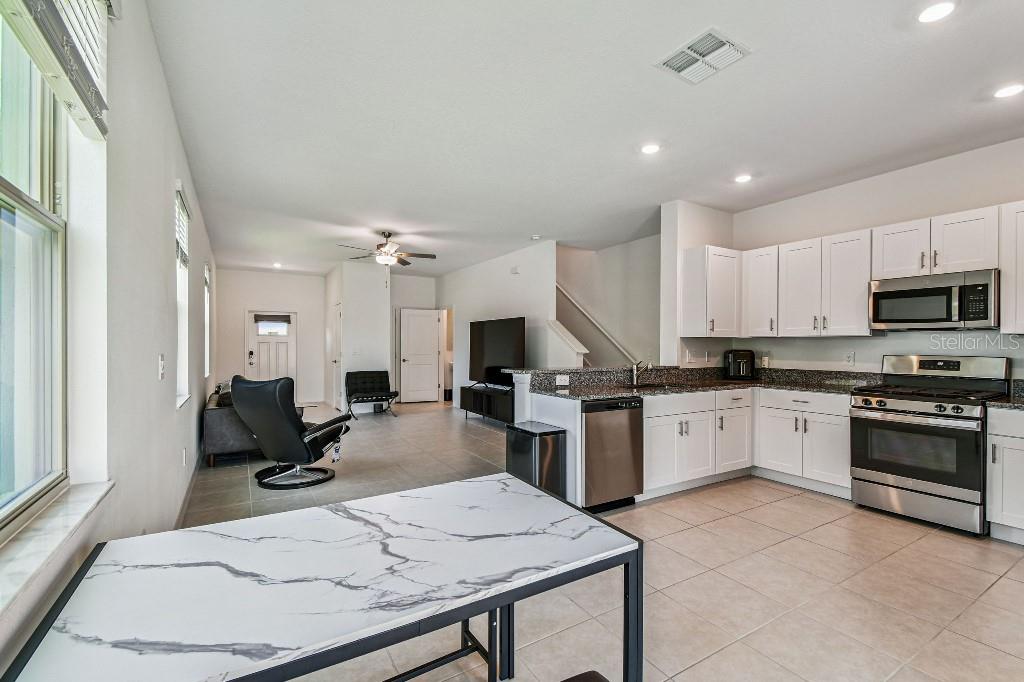 8331 Corner Pine Way New Port Richey, FL 34655 - Photo 17 of 41 a kitchen with sink refrigerator and microwave