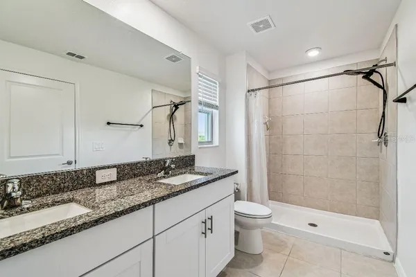 a bathroom with a shower and a toilet