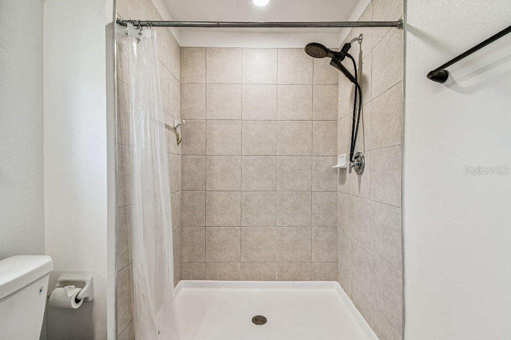8331 Corner Pine Way New Port Richey, FL 34655 - Photo 36 of 41 a bathroom with a shower and a toilet
