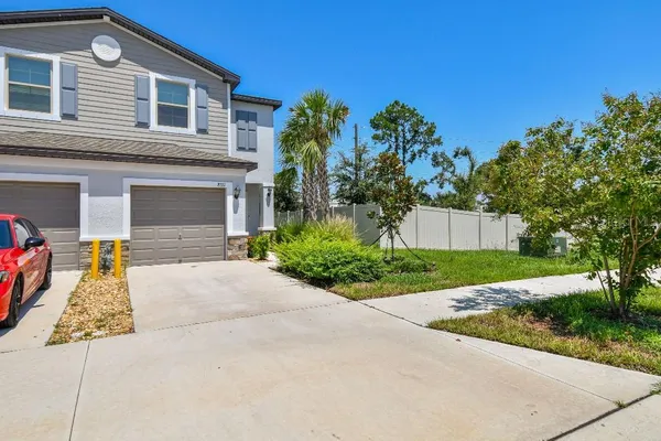 a front view of a house with a yard and a garage