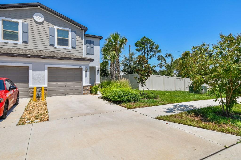 8331 Corner Pine Way New Port Richey, FL 34655 - Photo 5 of 41 a front view of a house with a yard and a garage