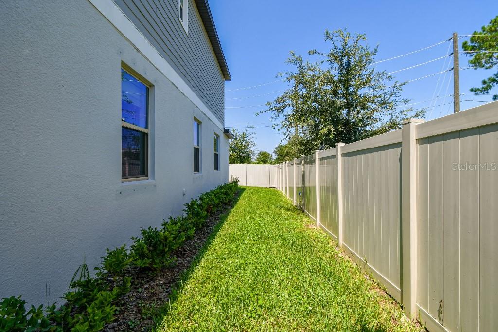 8331 Corner Pine Way New Port Richey, FL 34655 - Photo 7 of 41 a view of backyard with garden