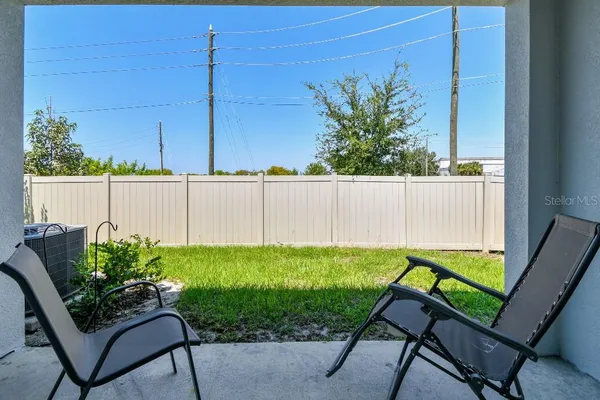 a view of a backyard with a chair and a table