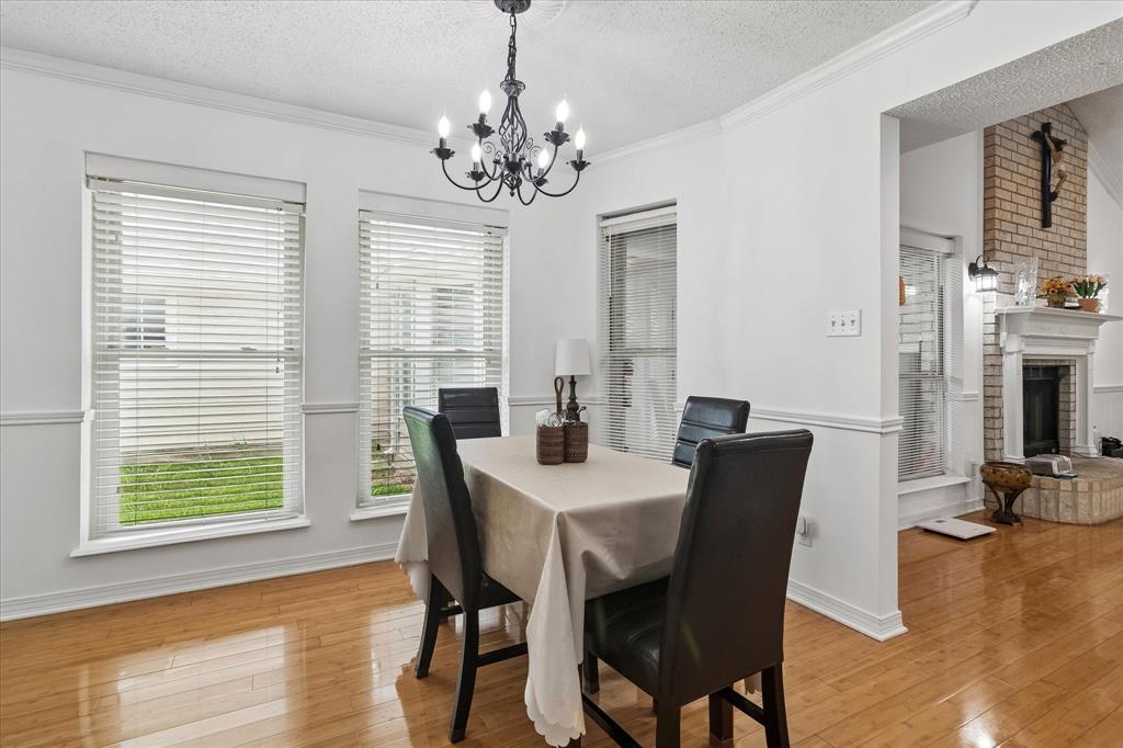 3007 McReynolds Road Sanger, TX 76266 - Photo 7 of 39 Dining area featuring wood-finish flooring and crown molding