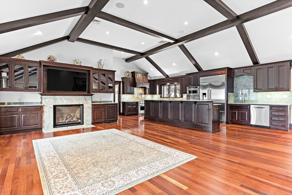 10 Viking Road Winchester, MA 01890 - Photo 11 of 42 a living room with stainless steel appliances kitchen island granite countertop furniture wooden floor and a fireplace