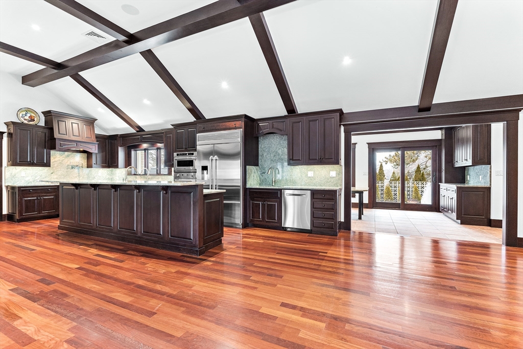 10 Viking Road Winchester, MA 01890 - Photo 12 of 42 a large kitchen with stainless steel appliances granite countertop a stove and cabinets