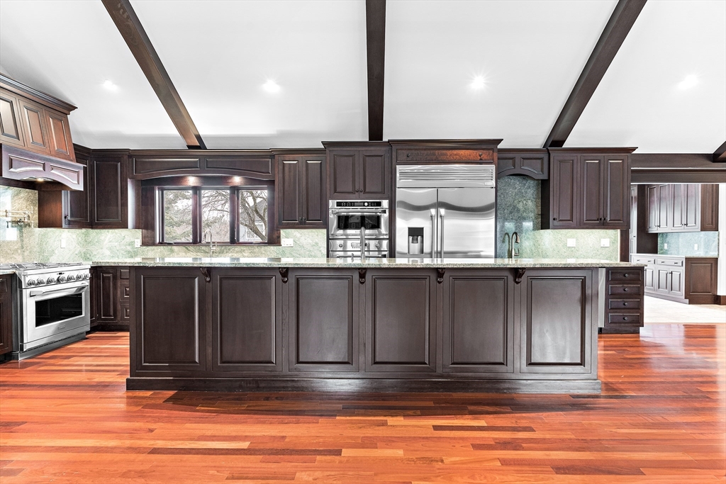 10 Viking Road Winchester, MA 01890 - Photo 14 of 42 a living room with stainless steel appliances kitchen island granite countertop a refrigerator a stove and a sink