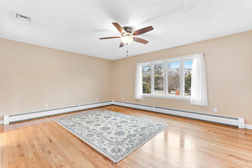 10 Viking Road Winchester, MA 01890 - Photo 23 of 42 a view of an empty room with wooden floor and a window